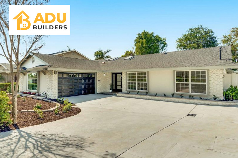 A modern ADU with clean lines, large glass windows, emphasizing natural light and contemporary aesthetics.